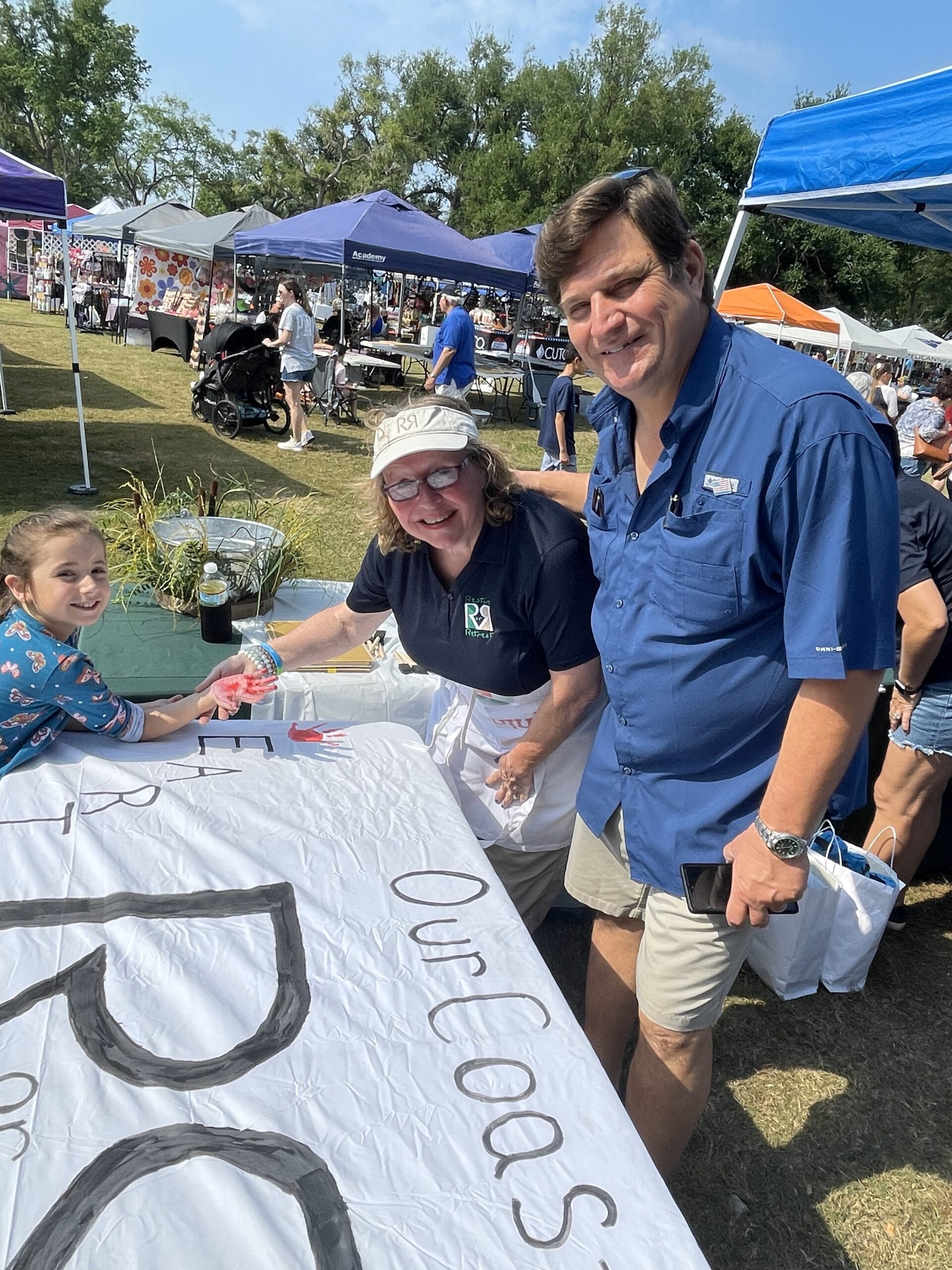 Hand Painting on sign at Golden Meadow's Balloons & Boulettes Festival